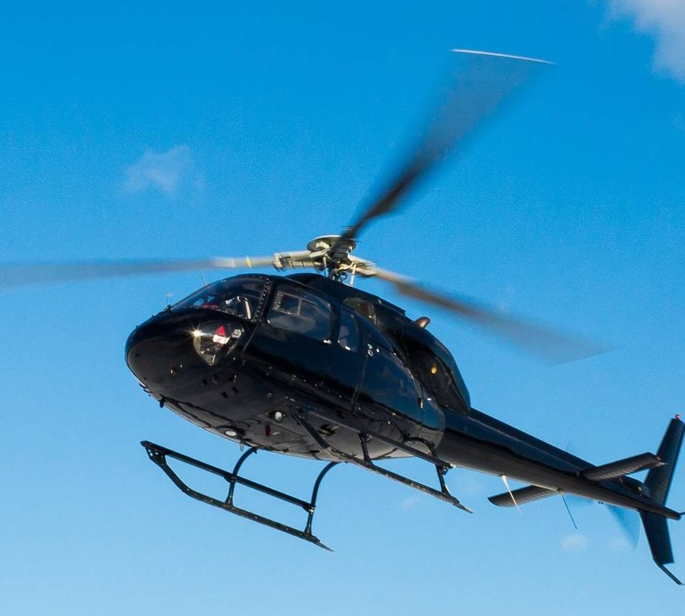 solo black helicopter in blue skies